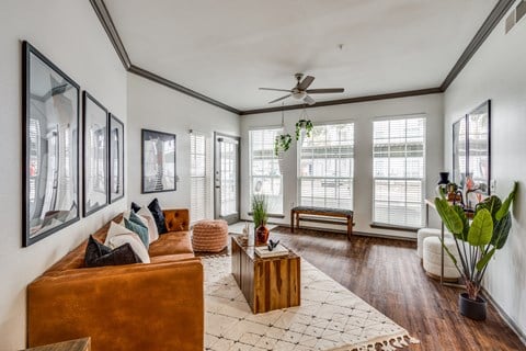 a living room with a couch and a ceiling fan